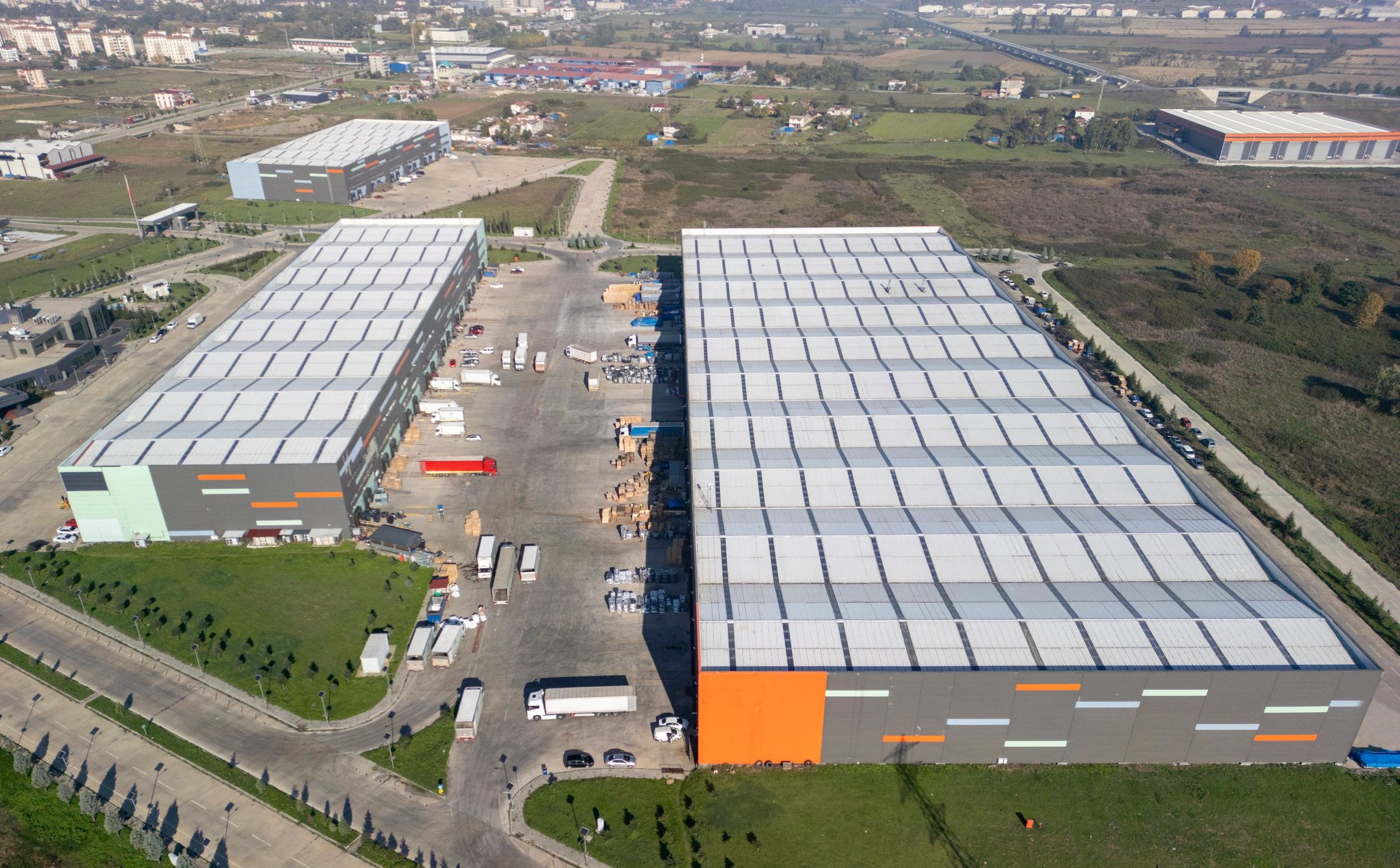 Modern logistics warehouses and trucks supporting coordinated supply chains